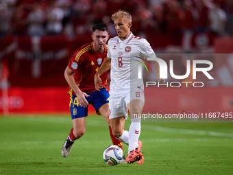 Isaksen of Denmark competes for the ball with Aymeric Laporte of Spain during the UEFA Nations League 2024/25 League A Group A4 game between...