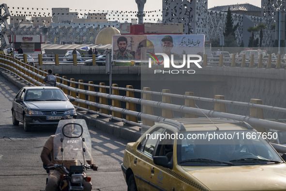 A banner features portraits of a commander of the Islamic Revolutionary Guard Corps' (IRGC) Quds Force, Abbas Nilforoushan, who is killed in...