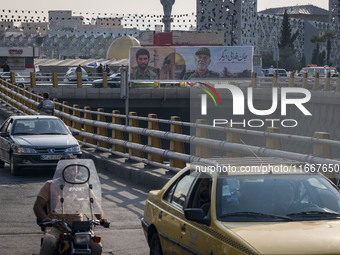 A banner features portraits of a commander of the Islamic Revolutionary Guard Corps' (IRGC) Quds Force, Abbas Nilforoushan, who is killed in...