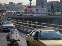 A banner features portraits of a commander of the Islamic Revolutionary Guard Corps' (IRGC) Quds Force, Abbas Nilforoushan, who is killed in...