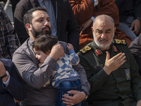 Hossein Salami, commander-in-chief of the Islamic Revolutionary Guard Corps (IRGC), beats himself while sitting next to a son of a commander...