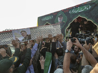 Iranian mourners carry a coffin containing the body of a commander of the Islamic Revolutionary Guard Corps' (IRGC) Quds Force, Abbas Nilfor...