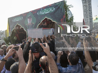 Iranian mourners carry a coffin containing the body of a commander of the Islamic Revolutionary Guard Corps' (IRGC) Quds Force, Abbas Nilfor...