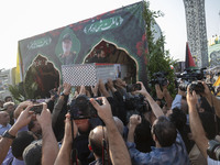 Iranian mourners carry a coffin containing the body of a commander of the Islamic Revolutionary Guard Corps' (IRGC) Quds Force, Abbas Nilfor...