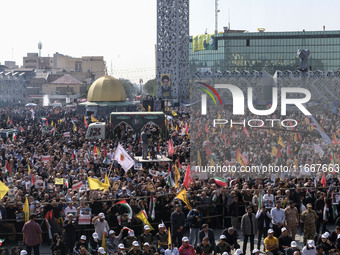 Iranian mourners take part in a funeral while a truck carrying a coffin containing the body of a commander of the Islamic Revolutionary Guar...