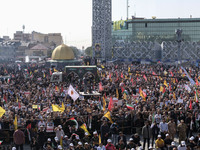 Iranian mourners take part in a funeral while a truck carrying a coffin containing the body of a commander of the Islamic Revolutionary Guar...