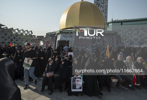 Iranian mourners hold portraits of Iran's Supreme Leader, Ayatollah Ali Khamenei, and a commander of the Islamic Revolutionary Guard Corps'...