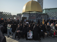 Iranian mourners hold portraits of Iran's Supreme Leader, Ayatollah Ali Khamenei, and a commander of the Islamic Revolutionary Guard Corps'...