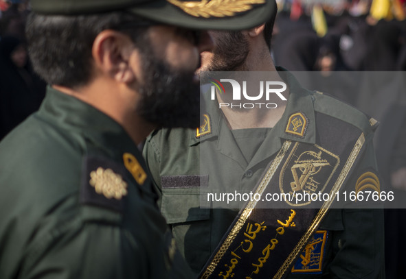 Two IRGC military personnel monitor an area during a funeral for a commander of the Islamic Revolutionary Guard Corps' (IRGC) Quds Force, Ab...