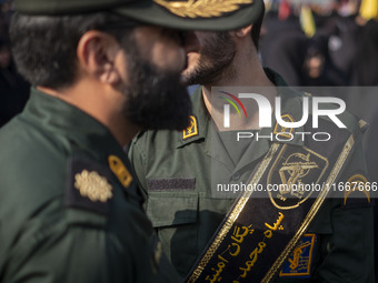 Two IRGC military personnel monitor an area during a funeral for a commander of the Islamic Revolutionary Guard Corps' (IRGC) Quds Force, Ab...