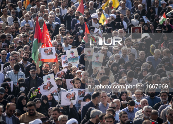 Iranian mourners hold portraits of a commander of the Islamic Revolutionary Guard Corps' (IRGC) Quds Force, Abbas Nilforoushan, who is kille...