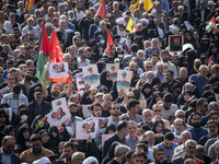 Iranian mourners hold portraits of a commander of the Islamic Revolutionary Guard Corps' (IRGC) Quds Force, Abbas Nilforoushan, who is kille...