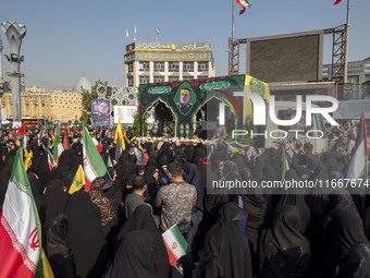 Iranian mourners take part in a funeral while a truck carries a coffin containing the body of a commander of the Islamic Revolutionary Guard...