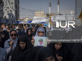 A veiled Iranian mourner holds a portrait of a commander of the Islamic Revolutionary Guard Corps' (IRGC) Quds Force, Abbas Nilforoushan, wh...