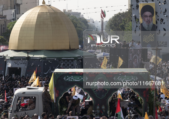 Iranian mourners take part in a funeral as a truck carries a coffin containing the body of a commander of the Islamic Revolutionary Guard Co...