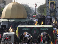 Iranian mourners take part in a funeral as a truck carries a coffin containing the body of a commander of the Islamic Revolutionary Guard Co...