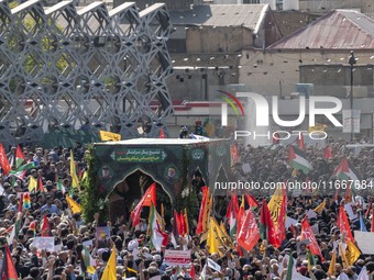 Iranian mourners take part in a funeral while a truck carries a coffin containing the body of a commander of the Islamic Revolutionary Guard...