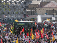 Iranian mourners take part in a funeral while a truck carries a coffin containing the body of a commander of the Islamic Revolutionary Guard...