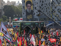 Iranian mourners take part in a funeral while a truck carries a coffin containing the body of a commander of the Islamic Revolutionary Guard...