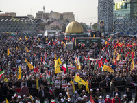 Iranian mourners take part in a funeral as a truck carries a coffin containing the body of a commander of the Islamic Revolutionary Guard Co...