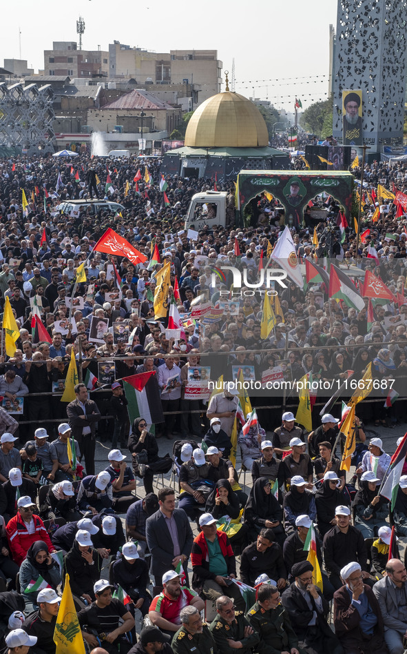 Iranian mourners take part in a funeral as a truck carries a coffin containing the body of a commander of the Islamic Revolutionary Guard Co...