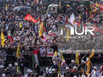 Iranian mourners take part in a funeral as a truck carries a coffin containing the body of a commander of the Islamic Revolutionary Guard Co...