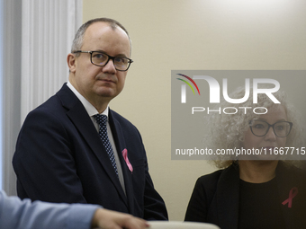 Polish Minister of Justice Adam Bodnar (L) and Equality Minister Katarzyna Kotula (R) look on as they arrive at the weekly ministerial meeti...