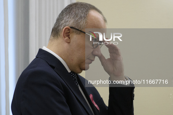 Polish Minister of Justice Adam Bodnar adjusts his glasses as he arrives at the weekly Ministerial meeting in Warsaw, Poland, on October 15,...