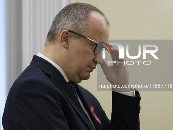 Polish Minister of Justice Adam Bodnar adjusts his glasses as he arrives at the weekly Ministerial meeting in Warsaw, Poland, on October 15,...