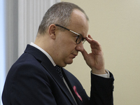 Polish Minister of Justice Adam Bodnar adjusts his glasses as he arrives at the weekly Ministerial meeting in Warsaw, Poland, on October 15,...