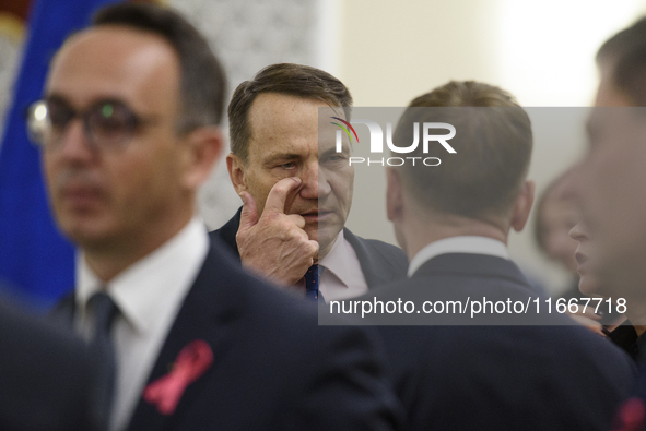 Polish Minister of Foreign Affairs Radoslaw Sikorski scratches his eye as he arrives at the weekly Ministerial meeting in Warsaw, Poland, on...