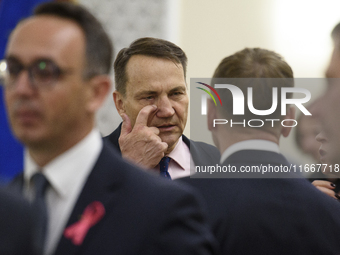 Polish Minister of Foreign Affairs Radoslaw Sikorski scratches his eye as he arrives at the weekly Ministerial meeting in Warsaw, Poland, on...