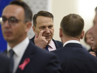 Polish Minister of Foreign Affairs Radoslaw Sikorski scratches his eye as he arrives at the weekly Ministerial meeting in Warsaw, Poland, on...