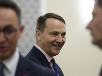 Polish Minister of Foreign Affairs Radoslaw Sikorski talks as he arrives at the weekly Ministerial meeting in Warsaw, Poland, on October 15,...