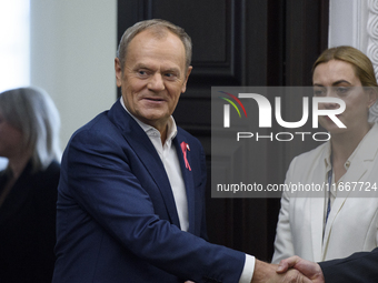 Poland's PM Donald Tusk looks on as he arrives at the weekly Ministerial meeting in Warsaw, Poland, on October 15, 2024. (