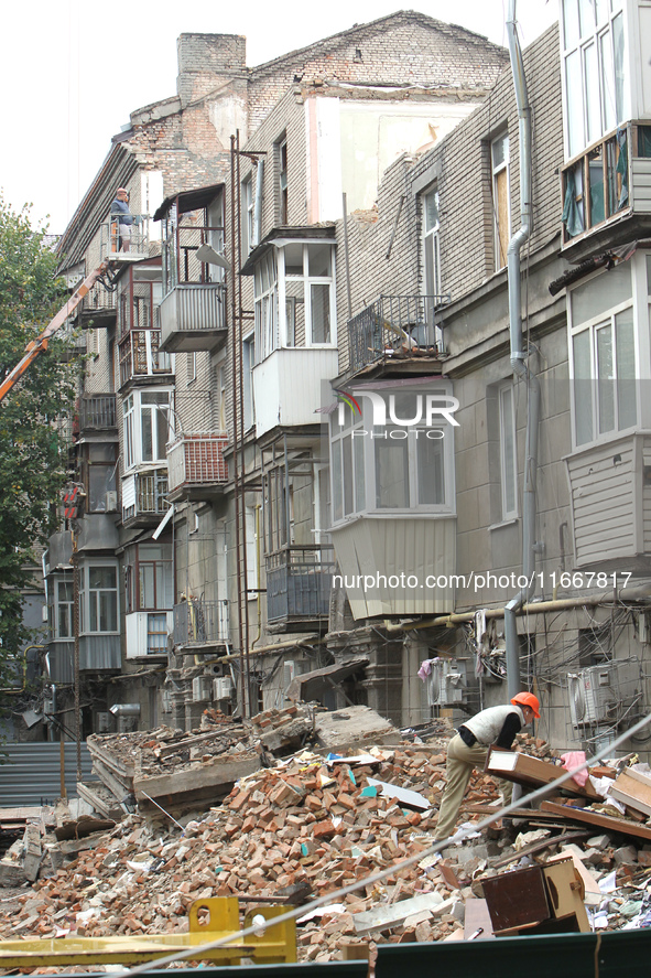 A worker is at a pile of rubble at the apartment block in Vokzalna Square that was hit by a Russian missile on April 19, 2024, and is being...