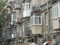 A worker is at a pile of rubble at the apartment block in Vokzalna Square that was hit by a Russian missile on April 19, 2024, and is being...