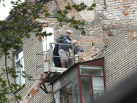 Workers are at a pile of rubble at the apartment block in Vokzalna Square that is being dismantled in Dnipro, Ukraine, on October 14, 2024....