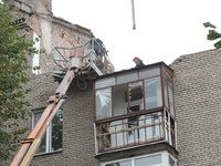 Workers are at a pile of rubble at the apartment block in Vokzalna Square that is being dismantled in Dnipro, Ukraine, on October 14, 2024....