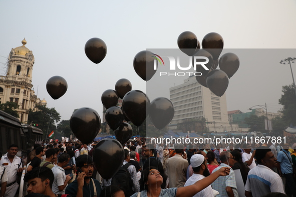 Citizens hold black balloons while doctors and citizens shout slogans during a protest carnival, the ''Droho carnival,'' demanding that Indi...