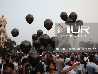 Citizens hold black balloons while doctors and citizens shout slogans during a protest carnival, the ''Droho carnival,'' demanding that Indi...