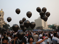 Citizens hold black balloons while doctors and citizens shout slogans during a protest carnival, the ''Droho carnival,'' demanding that Indi...