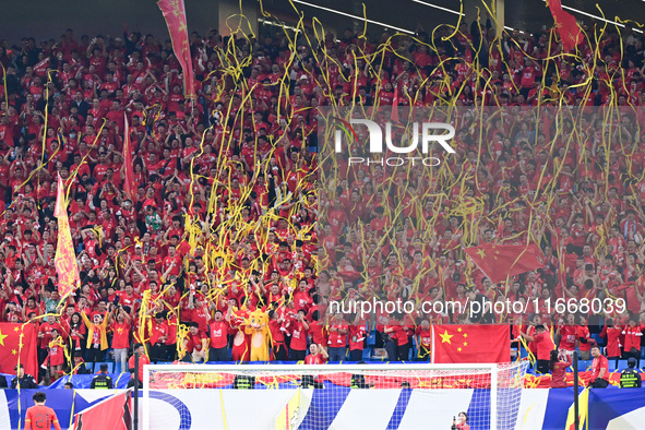 Fans cheer for China during their football match against Indonesia in the fourth round of the World Cup Qualifiers in Qingdao, China, on Oct...