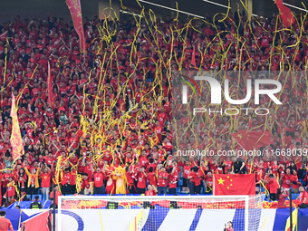 Fans cheer for China during their football match against Indonesia in the fourth round of the World Cup Qualifiers in Qingdao, China, on Oct...