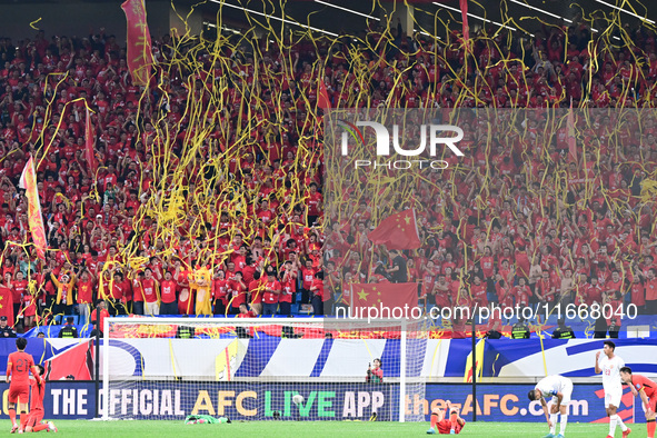 Fans cheer for China during their football match against Indonesia in the fourth round of the World Cup Qualifiers in Qingdao, China, on Oct...