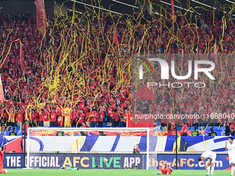 Fans cheer for China during their football match against Indonesia in the fourth round of the World Cup Qualifiers in Qingdao, China, on Oct...