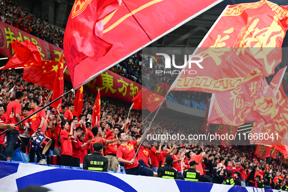 Fans cheer for China during their football match against Indonesia in the fourth round of the World Cup Qualifiers in Qingdao, China, on Oct...