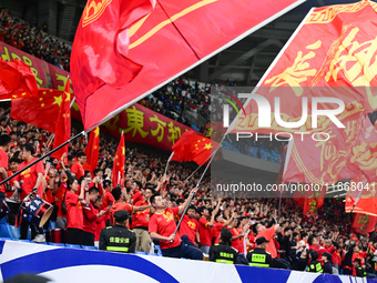 Fans cheer for China during their football match against Indonesia in the fourth round of the World Cup Qualifiers in Qingdao, China, on Oct...