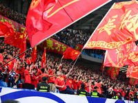 Fans cheer for China during their football match against Indonesia in the fourth round of the World Cup Qualifiers in Qingdao, China, on Oct...