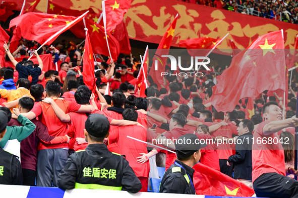 Fans cheer for China during their football match against Indonesia in the fourth round of the World Cup Qualifiers in Qingdao, China, on Oct...